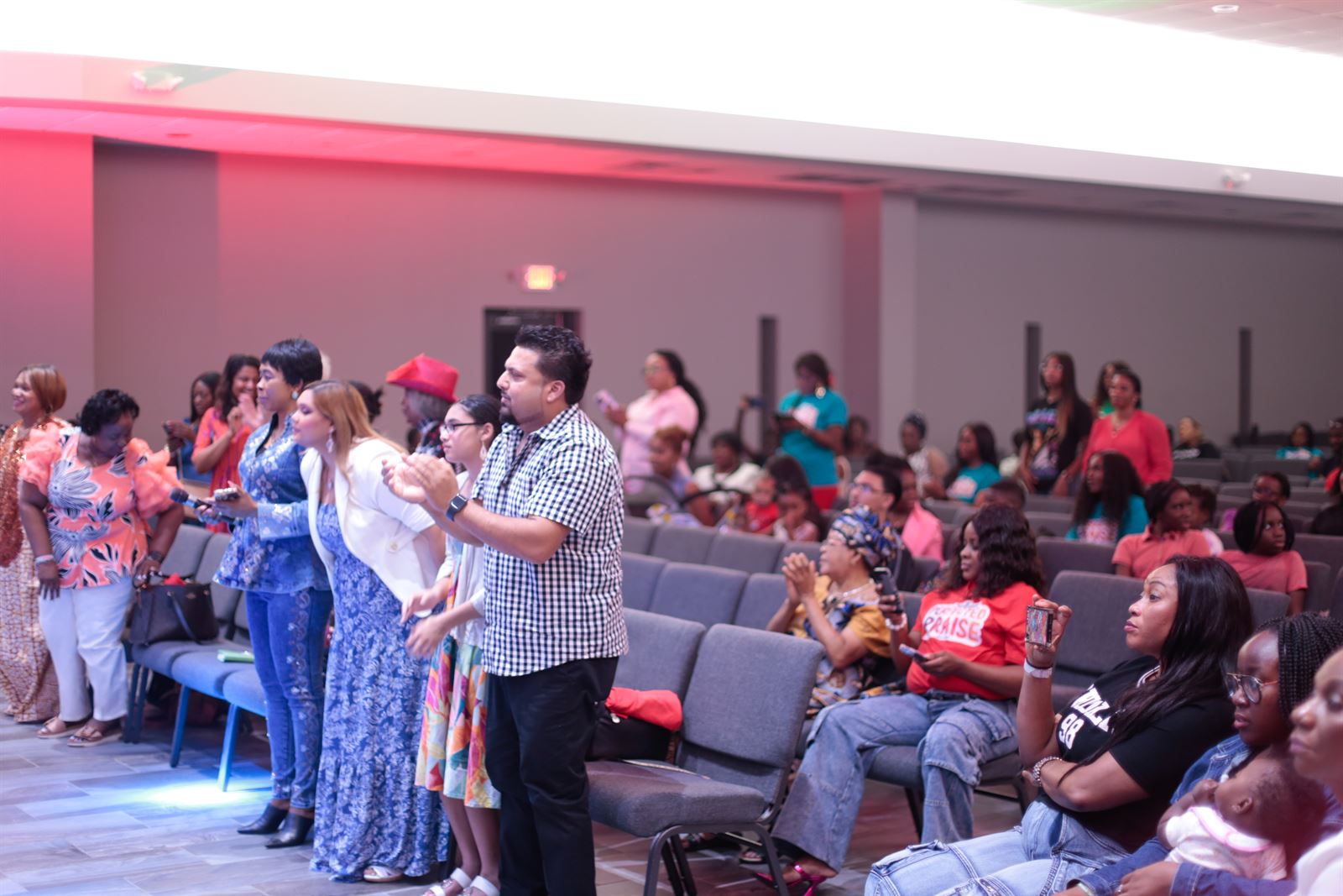 A packed house on its feet in praise